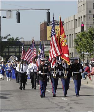 The Marine Corps honor guard carries the colors near the front of the Memorial Day parade downtown. A commemorative service was held, remembering those who died serving in the country’s armed forces. FOR A PHOTO GALLERY, GO TO TOLEDOBLADE.COM.