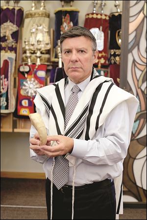 Cantor Ivor Lichterman of Congregation B’nai Israel in Sylvania shows a shofar.