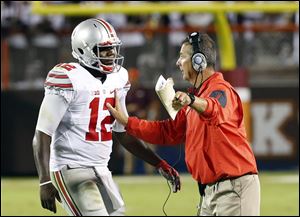 Ohio State head coach Urban Meyer, right, talks with quarterback Cardale Jones (12).