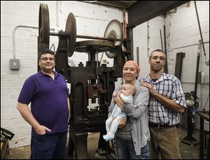 Dan Lund, left, Rachel McCartney with daughter Violet Christy, 4 months, and her partner, J.C. Christy, at Deep In Design. The trio were happy to take the press from Roulet Jewelers, who have moved to smaller quarters on Lewis Avenue.