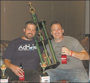 The title of Biggest AdHOLE for 2015 (corn hole champions) went to James Owen, left, Brad Hughes at the AdHOLE cornhole tournament at the Premier banquet hall.