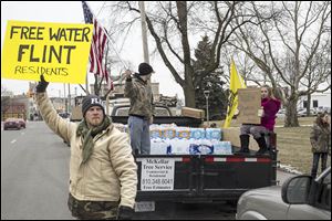 Genesee County Volunteer Militia members and protesters gather for a rally outside of Flint City Hall over the city’s ongoing water crisis. The militia was handing out free bottled water and water filters. 