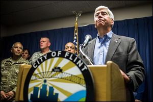 Gov. Rick Snyder speaks about the Flint, Mich., water crisis during a news conference at city hall in downtown Flint.