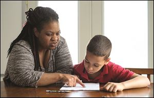 Debra Wilkins helps her son Jayden, 10, with his homework Tuesday April 26, 2016, in Toledo , Ohio. Jayden has fetal alcohol exposure and as a result requires  help in school.