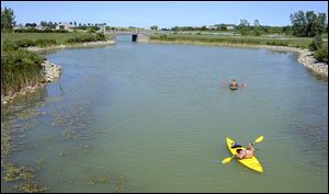 People ride kayaks at Maumee Bay State Park in Oregon. Local leaders discussed an amendment in the House state budget bill that, they said, would endanger parks like Maumee Bay.