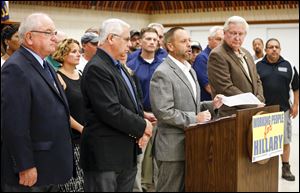 Ohio AFL-CIO President Tim Burga speaks at the  UAW Local 12 hall. From left are Ohio State Building and Construction Trades Council Secretary-Treasurer Dennis Duffey, UAW Region 2-B Director Ken Lortz, and United Steelworkers District 1 Director Dave McCall.