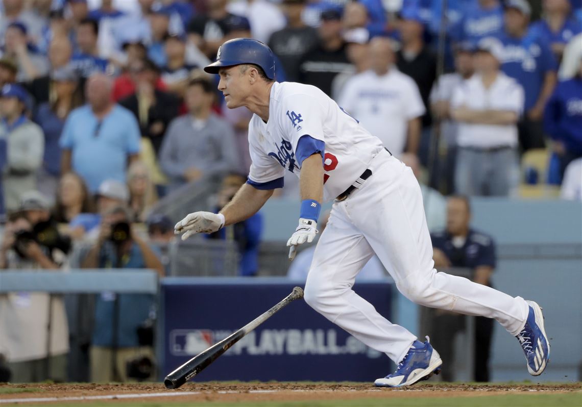 Los Angeles Dodgers' Andrew Toles, right, scores past Washington Nationals  relief pitcher Blake Treinen on a single by Chase Utley during the eighth  inning in Game 4 of baseball's National League Division