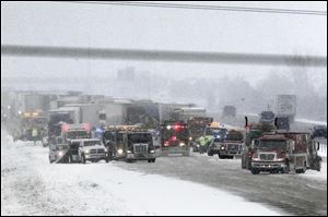 Crews work to untangle a 21-vehicle pileup on northbound I-75 north of State Rt. 582 in Wood County. Three people were hurt seriously and three suffered minor injuries Friday.