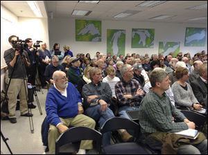 People listen to speakers at the International Joint Commission meeting about proposed cuts to the Lake Erie budget.