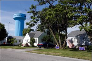 Fostoria's water tower behind several homes on Buckley St. in Fostoria. Councilman Mathew Davoli has proposed legislation that, if approved in on the November ballot, would give council the power to scrap police and fire departments or contract with other agencies to provide those services.