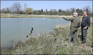 U.S. Sen. Rob Portman (R., Ohio), left, talks with University of Toledo Department of Environmental Sciences professor Daryl Dwyer at a restored wetland site near the entrance at Maumee Bay State Park in Oregon. 