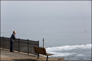 Malcolm Shore, of Temperance, walks along the pier lookig at the ice formations on Lake Erie in Luna Pier in February. Farmers are cheering and environmentalists are concerned with a recent move by the Trump administration to rollback a regulation designed to benefit water quality in Lake Erie.