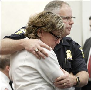 Toledo police Chief George Kral and Toledo Fire and Rescue Assistant Chief Karen Marquardt embrace after the trial of Ray Abou-Arab.