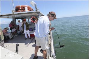 George Bullerjahn, professor of research excellence at Bowling Green State University, prepares to take measurements in Sandusky Bay.