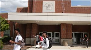 Bowsher High School students exit the building under a Rebel logo Friday. Discussions of changing the school's nickname and emblem intensified in the wake the death of a protester at a white supremacist rally in Charlottesville, Va.