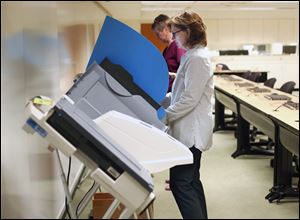 Ann Hosman Worden casts her ballot during the the primary at Way Public Library.