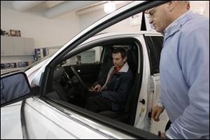 A customer looks at a car at Brondes Ford in 2010. Brondes Ford Lincoln plans to move to Arrowhead Park in Maumee from its current location on Reynolds Road. 