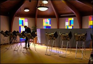 A Toledoan votes in Tuesday’s primary at Washington Church on West Central Avenue. Despite a computer malfunction, election results were reported earlier than in most years.