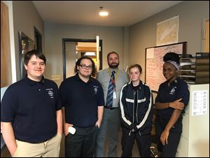 From left, Casey Meeker, Charles Boisselle, Principal Aaron Lusk, Peyton Knapp, and Nadhira Hunter discuss the Maritime Academy of Toledo.