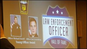 Toledo police officers Michael Futrell and John Gruenberg were awarded with the Law Enforcement Officer Hall of Fame's Young Officer Award for helping to save a mother and her three children from a fatal apartment fire at the Woodlands Apartment building in January. 