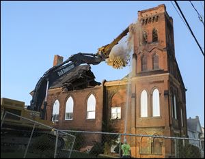 The former Calvary Bible Pentecostal Holiness Church is demolished Tuesday.