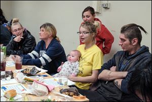 Amanda McCourt, left; her mother Wendy Cunningham; Amanda's sister Cynthia McCourt, standing; Lydia Smith, with Amanda McCourt's baby; Nicole Rahmel, four months old; and Lydia's husband Cody Smith.  Lydia Smith, who is 27 weeks pregnant, came to the event because she has been told her baby will be premature.