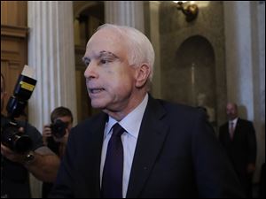 Sen. John McCain, R-Ariz., leaves the chamber as the Republican-run Senate rejected a GOP proposal to scuttle President Barack Obama's health care law in July.