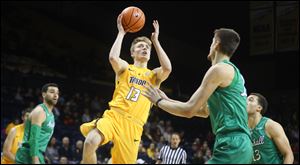 Jaelan Sanford of Toledo shoots over Marshall's Ajdin Penava.