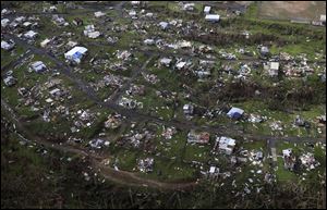 Homes and other buildings destroyed by Hurricane Maria lie in ruins in Toa Alta, Puerto Rico, on Sept. 28. Much of the country is still without power.