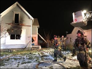 Toledo firefighters began to wrap up their hoses and assess the damage to a North Toledo home that caught fire at about 7:30 p.m. Sunday. No one was home except for three dogs that firefighters pulled from the home and resuscitated.