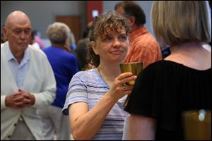 Marie Clark-Phelps accepts the consecrated wine during Sunday mass at St. John XXIII in Perrysburg on July 2, 2017.