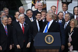 From left, Senate Majority Leader Mitch McConnell, Vice President Mike Pence, House Speaker Paul Ryan and Republican lawmakers react as President Donald Trump speaks during a celebration of the passage of the tax overhaul bill.