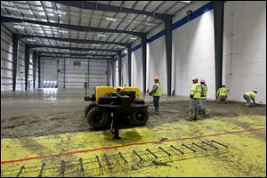 Rudolph-Libbe employees create a concrete floor for the addition to a Johnson Controls plant in Holland, Ohio.