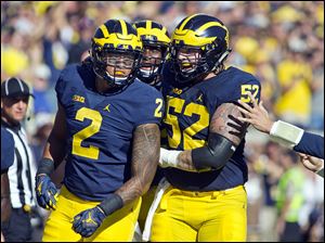 Michigan tight end Devin Asiasi (2) celebrates his touchdown reception with offensive lineman Mason Cole (52) in the first half of an NCAA college football game against Penn State at Michigan Stadium in Ann Arbor, Mich., Saturday, Sept. 24, 2016.