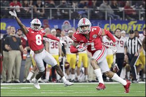 Ohio State safety Damon Webb runs an interception in for a touchdown in front of cornerback Kendall Sheffield during the first half of the Cotton Bowl against Southern California.