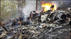 This photo released by Costa Rica's Civil Aviation press office shows the site of a plane crash in Punta Islita, Guanacaste, Costa Rica, Sunday. A government statement says there were 10 foreigners and two Costa Rican crew members aboard the plane belonging to Nature Air, which had taken off nearby.