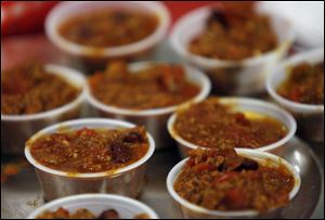 Chili samples are lined up at the Red Hat Hotties of West Park Place booth at the Mobile Meals of Toledo Chili Cookoff in 2008.