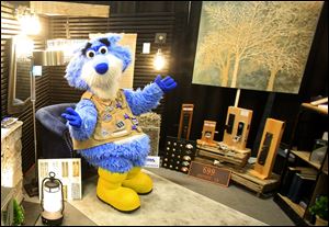 Toledo Walleye mascot CatTrick poses on a chair in a Gross Electric display during the HBA House and Home show at the SeaGate Convention Centre in Toledo on Sunday, February 18, 2018. 