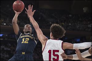 Michigan guard Muhammad-Ali Abdur-Rahkman goes to the basket against Nebraska forward Isaiah Roby.