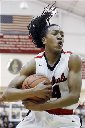 Cardinal Stritch's Little Anderson pulls down a rebound during a district semifinal matchup against Genoa. Cardinal Stritch advanced with a 59-53 win.