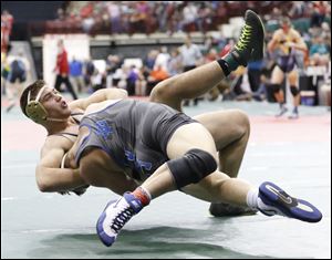 Maumee's Brandon Phillips is thrown by Breslin Walker of Cuyahoga Falls CVCA as time expires during their 220-pound Division II first round match at the state wrestling tournament. Phillips won the match. 