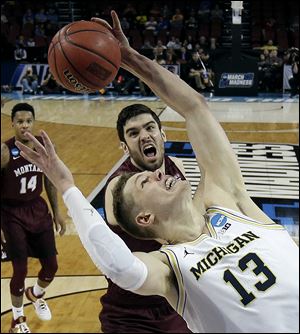 Michigan forward Moritz Wagner beats Montana forward Fabijan Krslovic to a rebound during Thursday's first round NCAA Tournament game. The Wolverines face Houston Saturday evening in the second round.