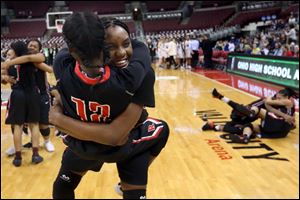 Rogers' Tanaziah Hines embraces Cossiana King (12) after the Rams beat Gilmour Academy for the state title.