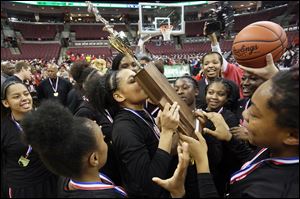 Rogers' Zia Cooke kisses the state championship trophy after the Rams beat Gilmour Academy in the Saturday, March 17, 2018, Division II state championship matchup at Value City Arena in Columbus. 