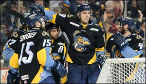 Toledo Walleye forward Shane Berschbach (10), center, celebrates scoring a goal against the Fort Wayne Komets on April 6.