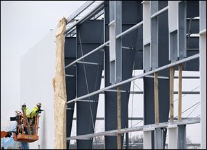 Rudolph Libbe workers build a factory addition onto the Betco plant Tuesday, April 10, 2018, in Bowling Green.