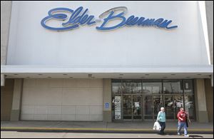 Tom and Terry Otley of Bowling Green leave the Elder-Beerman store at Westgate after a shopping trip on Wednesday in Toledo.