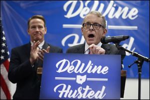 Ohio Attorney General and former U.S. Sen. Mike DeWine, right, speaks alongside running mate and Ohio Secretary of State Jon Husted in November of 2017.