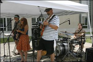 Glinda's Bubble plays a Brown Bag Concert at the Main Branch of the Toledo Lucas County Public Library in 2010. The Main Library will host a concert Monday to kick off its summer reading challenge.