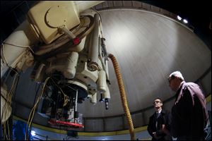 Ken Sembach, left, speaks with Noel Richardson as they look over the University of Toledo's telescope at Ritter Planetarium.